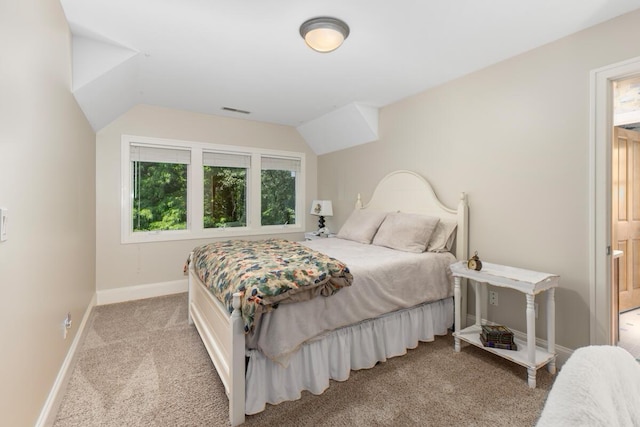 carpeted bedroom featuring lofted ceiling