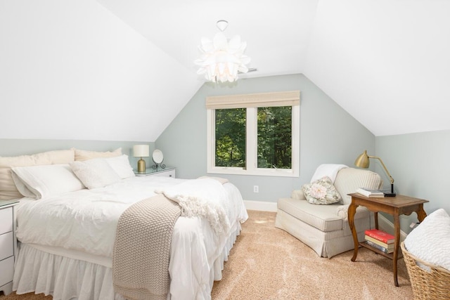 carpeted bedroom with lofted ceiling and an inviting chandelier