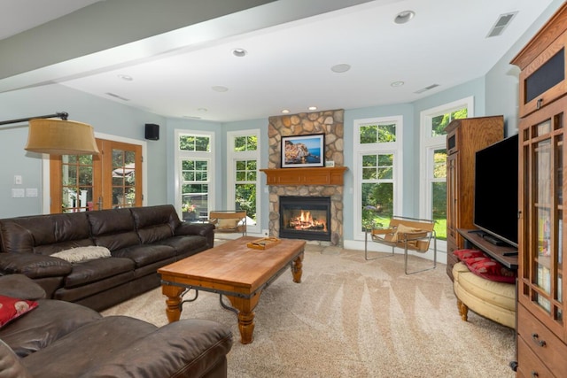 living room with french doors, light colored carpet, and a fireplace