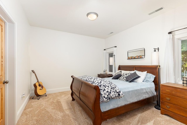 bedroom featuring light colored carpet