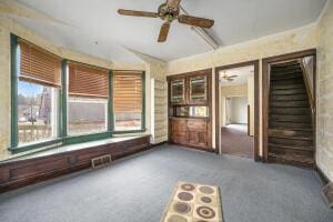 spare room with ceiling fan and carpet flooring