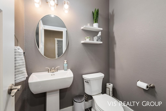 9340 Freedom Dr, West Olive, MI 49460 - half bath featuring a textured wall and toilet