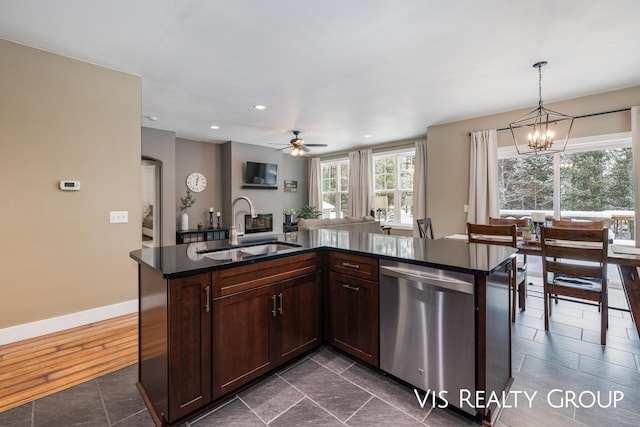 9340 Freedom Dr, West Olive, MI 49460 - kitchen with dark brown cabinetry, dark countertops, stainless steel dishwasher, a sink, and hanging light fixtures