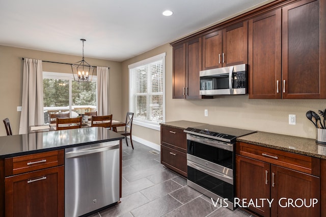 9340 Freedom Dr, West Olive, MI 49460 - kitchen featuring baseboards, an inviting chandelier, recessed lighting, appliances with stainless steel finishes, and hanging light fixtures
