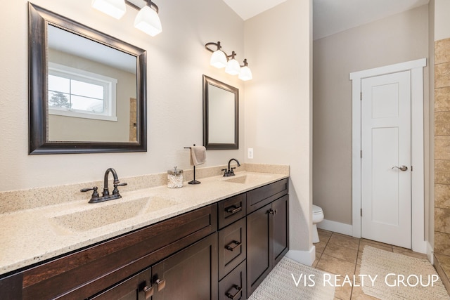 9340 Freedom Dr, West Olive, MI 49460 - full bathroom featuring a sink, tile patterned floors, toilet, and double vanity