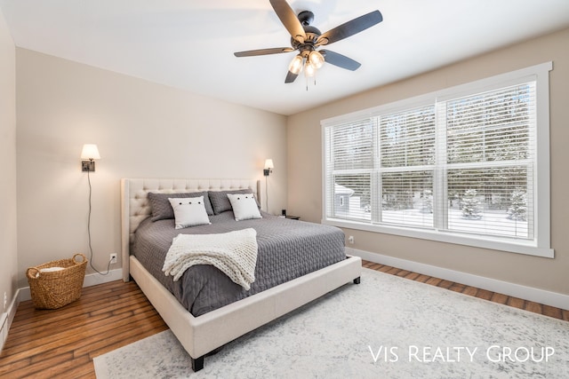9340 Freedom Dr, West Olive, MI 49460 - bedroom featuring baseboards, ceiling fan, and wood finished floors