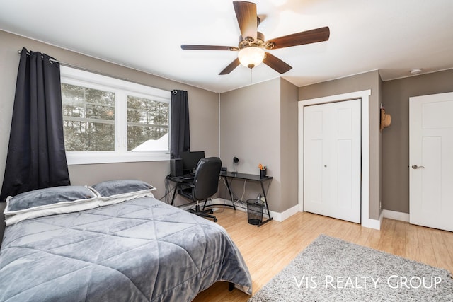 9340 Freedom Dr, West Olive, MI 49460 - bedroom featuring baseboards, a ceiling fan, and wood finished floors