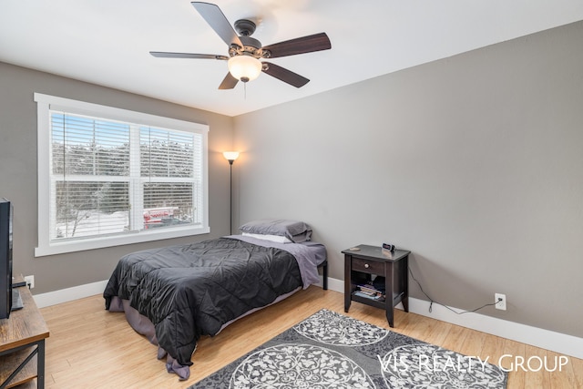 9340 Freedom Dr, West Olive, MI 49460 - bedroom featuring baseboards, ceiling fan, and wood finished floors