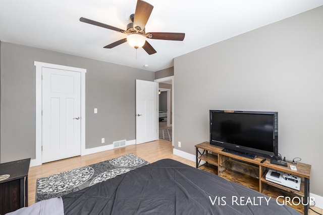 9340 Freedom Dr, West Olive, MI 49460 - bedroom featuring visible vents, baseboards, a ceiling fan, and wood finished floors