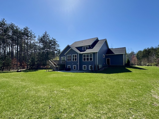 9340 Freedom Dr, West Olive, MI 49460 - back of property featuring stairway, a deck, and a lawn