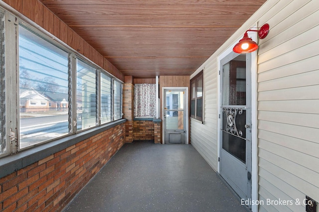 unfurnished sunroom featuring wood ceiling