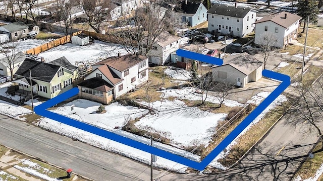 snowy aerial view featuring a residential view