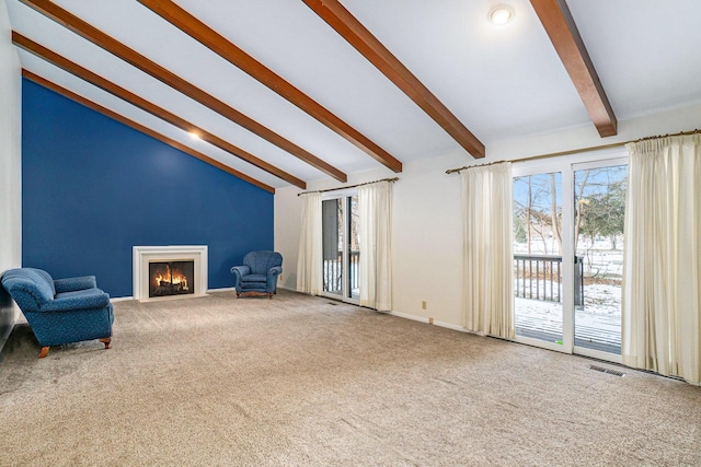 unfurnished room with lofted ceiling with beams and carpet