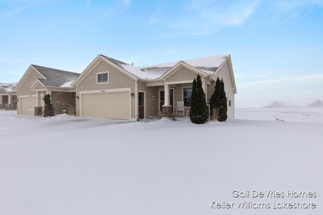 view of front of property with a garage and brick siding