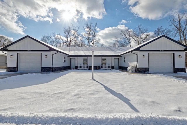 ranch-style house featuring a garage and covered porch