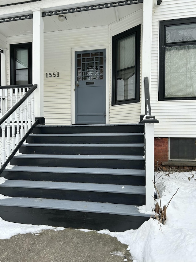 view of snow covered property entrance