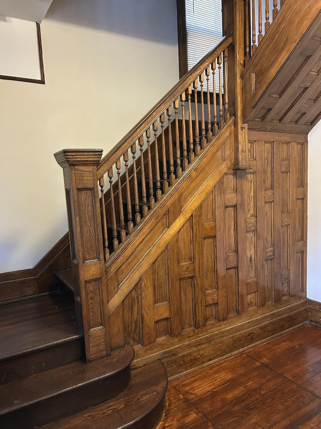 stairway with hardwood / wood-style floors