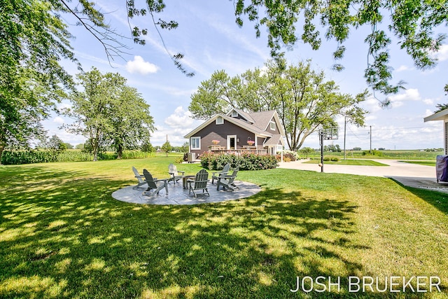 view of yard featuring a patio and an outdoor fire pit