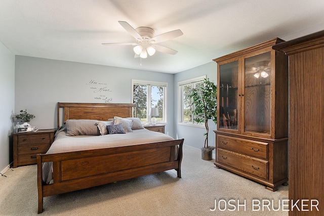 bedroom featuring light colored carpet and ceiling fan