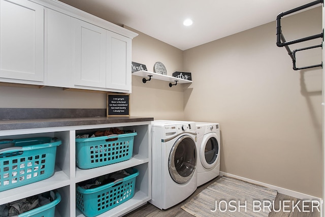 laundry area with cabinets, light wood-type flooring, and independent washer and dryer