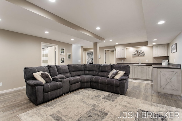 living room featuring indoor wet bar and light wood-type flooring