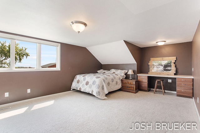 carpeted bedroom with vaulted ceiling