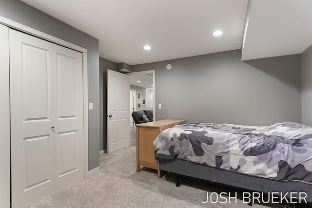 bedroom featuring light colored carpet and a closet