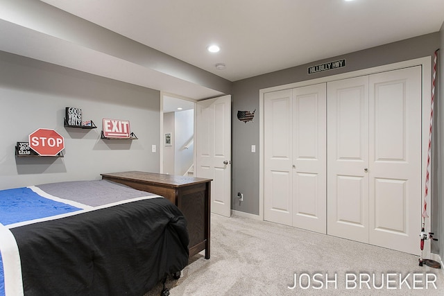 bedroom with light colored carpet and a closet