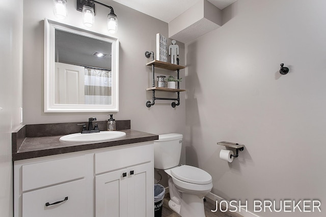 bathroom featuring vanity and toilet