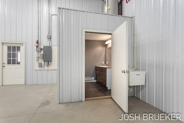 interior space featuring sink, electric panel, and baseboard heating