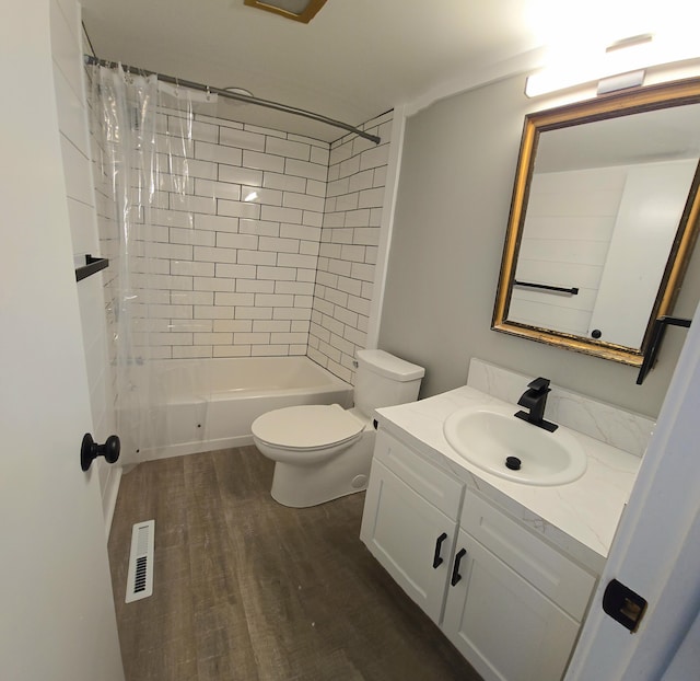 bathroom with bathing tub / shower combination, visible vents, toilet, vanity, and wood finished floors