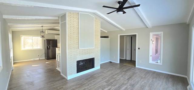 unfurnished living room with vaulted ceiling with beams, a brick fireplace, ceiling fan, and wood finished floors