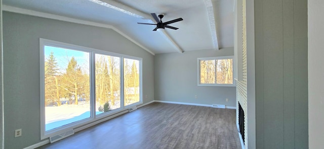 unfurnished room featuring lofted ceiling, visible vents, a ceiling fan, wood finished floors, and baseboards