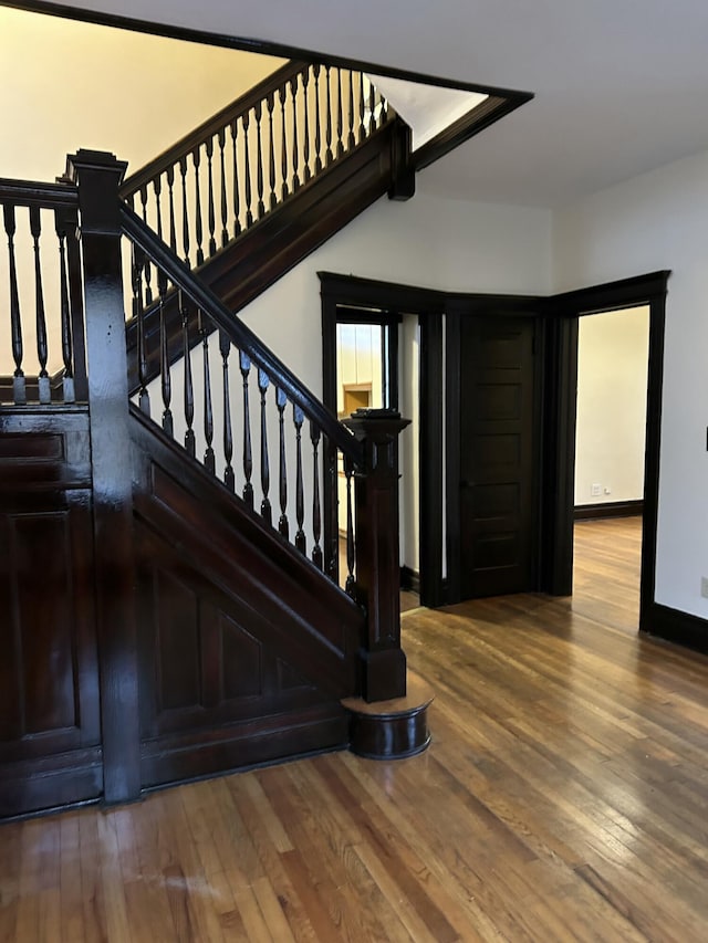 stairs with hardwood / wood-style floors