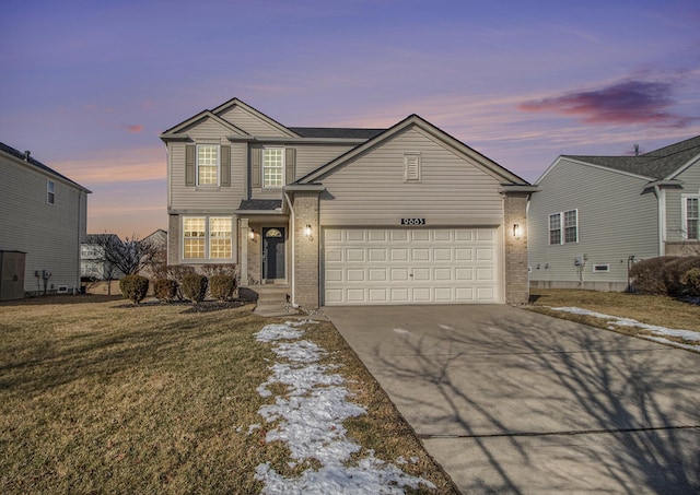 view of front property featuring a yard and a garage