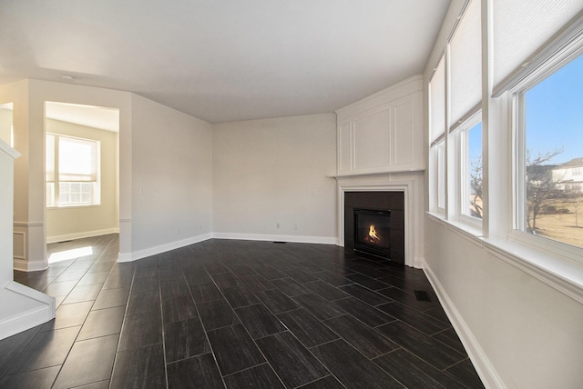 unfurnished living room featuring dark hardwood / wood-style floors and a large fireplace