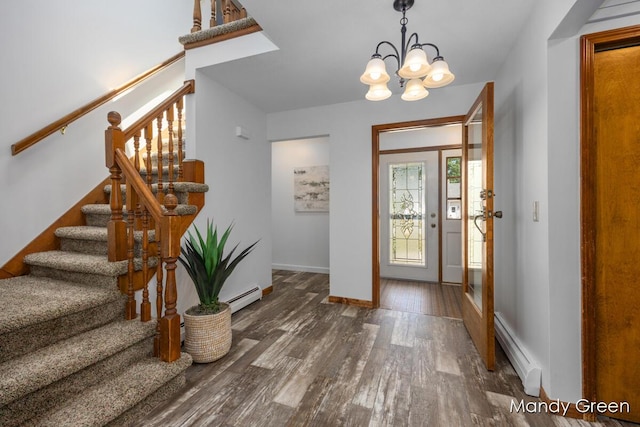 366 E Beech St NE, Cedar Springs, MI 49319 - foyer entrance featuring baseboard heating, wood finished floors, stairs, and a chandelier