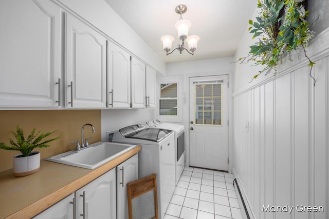 366 E Beech St NE, Cedar Springs, MI 49319 - laundry area with cabinet space, washer and dryer, light tile patterned floors, and a chandelier
