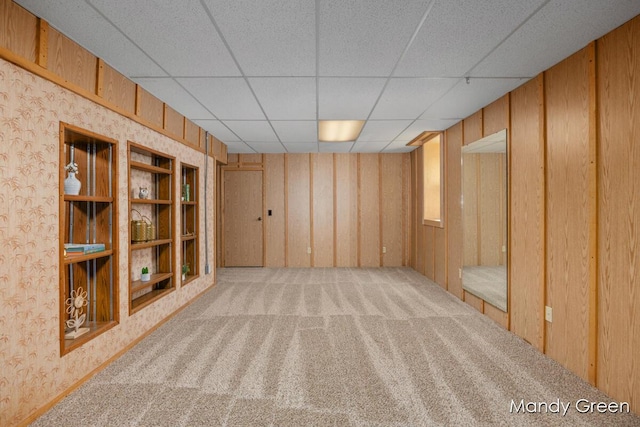 366 E Beech St NE, Cedar Springs, MI 49319 - carpeted spare room with a drop ceiling, wooden walls, and wallpapered walls