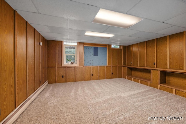 366 E Beech St NE, Cedar Springs, MI 49319 - below grade area with a baseboard radiator, carpet, a drop ceiling, and wood walls