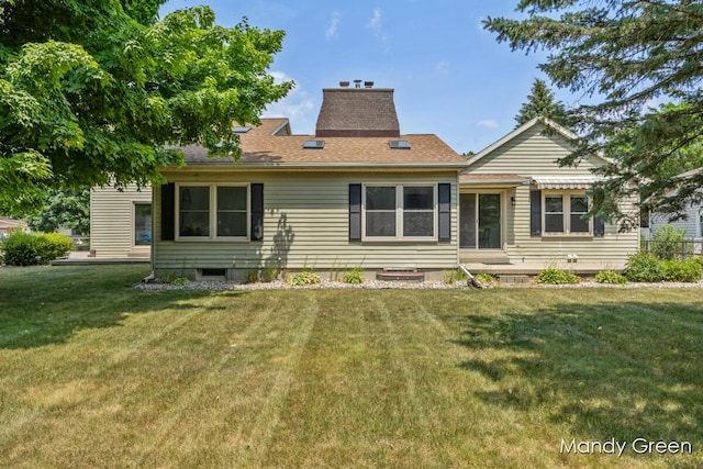 366 E Beech St NE, Cedar Springs, MI 49319 - rear view of property featuring a yard, a chimney, and roof with shingles