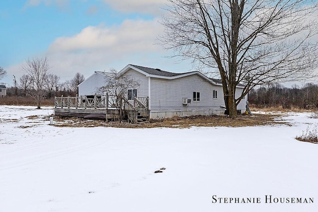 view of snow covered exterior featuring a deck