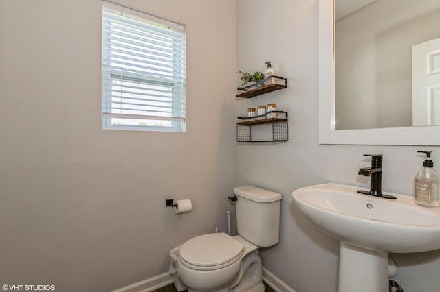 6058 Racine Dr, Stevensville, MI 49127 - half bathroom featuring plenty of natural light, baseboards, toilet, and a sink