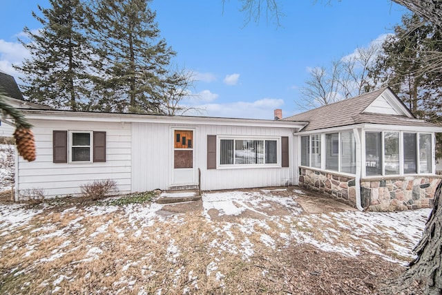 single story home featuring a sunroom