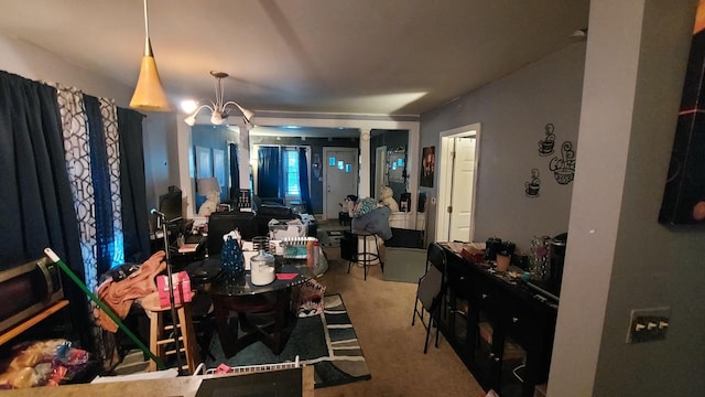 dining space featuring a notable chandelier and carpet floors