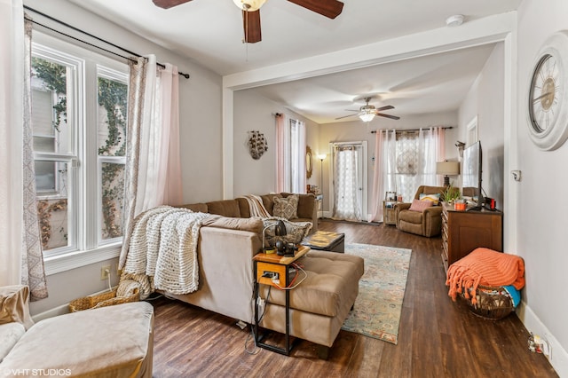 living room featuring dark wood-type flooring and ceiling fan