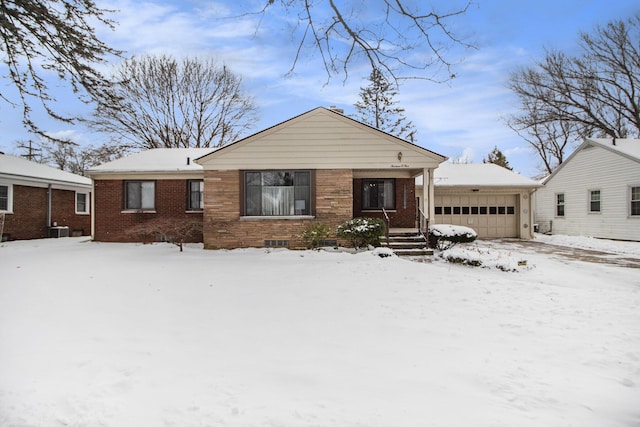 view of front of property featuring a garage and cooling unit