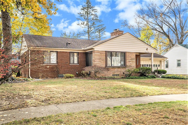 view of front of property with a front yard and a garage