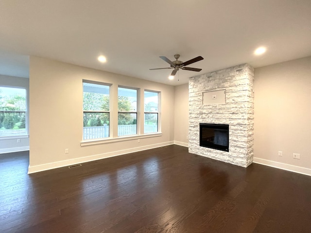 unfurnished living room featuring dark hardwood / wood-style flooring, plenty of natural light, and a fireplace