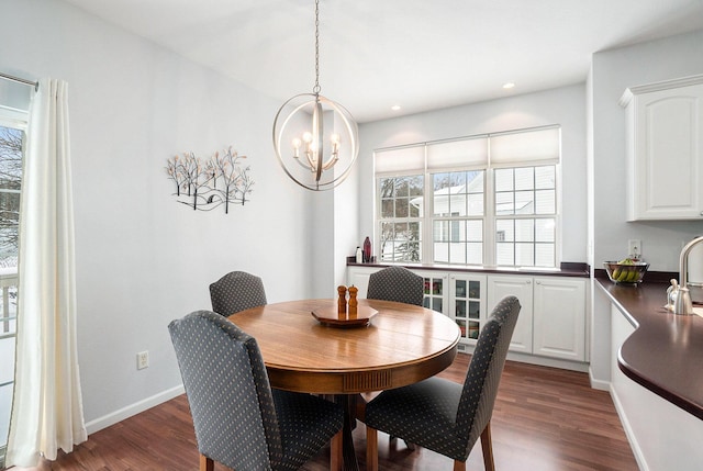 dining room featuring dark wood finished floors, a chandelier, recessed lighting, and baseboards